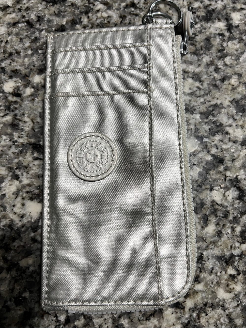 Kipling light silver zip pouch with interior logo tag